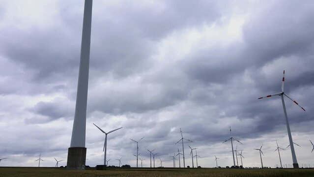 Wind turbines generate electricity when the wind is strong and the sky is very cloudy