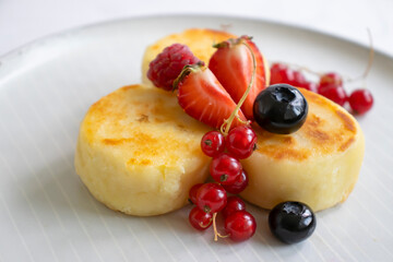 Cheesecakes with berries on a plate
