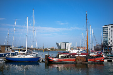 Yachts moored at Belfast harbor with Titanic Museum view in the background
