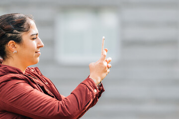 girl with mobile phone on the street in profile with copy-space