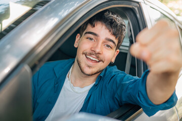 young or nobel driver celebrating in the euphoric car