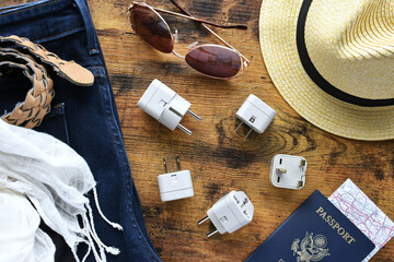 Travel essentials flat lay including power converter, voltage travel adapter 220v 110v Packing...
