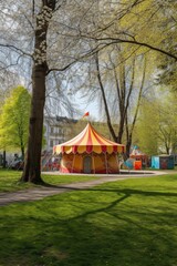 circus tent in a park with childrens playground nearby, created with generative ai