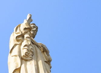 Sacred Heart Christ sandstone statue against blue sky on Mount Urgull in San Sebastian or Donostia...