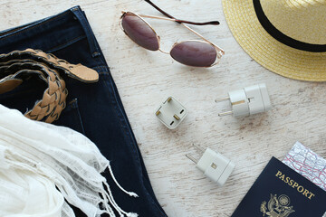 Travel essentials flat lay including power converter, voltage travel adapter 220v 110v Packing converters adapters for trips vacation in Europe UK Australia.