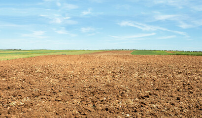 Freshly plowed farmland. The farmland is all moved and furrowed. It is ready to be sown with seeds....