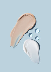 Cosmetic smears of cream texture on a blue background. Skin care.