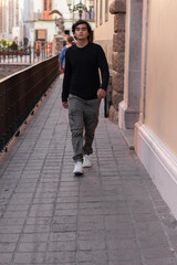 Young man traveling in Guanajuato, Mexico walking the streets