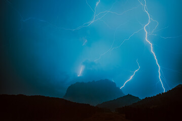 Fototapeta na wymiar Bright lightning over Alps mountains at night