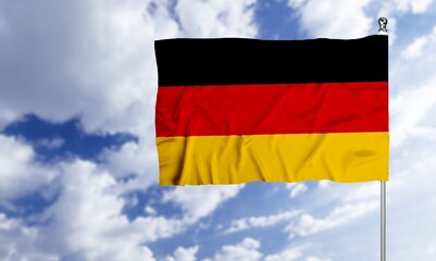The German flag wave in the wind on sky background