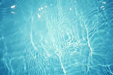 Blue water with ripples on the surface. Defocus blurred transparent blue colored clear calm water surface texture with splashes and bubbles. Water waves with shining pattern texture background.