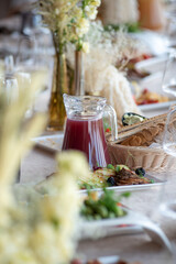 Beautiful wedding table decorations. Tablewear and bouquet of flowers.