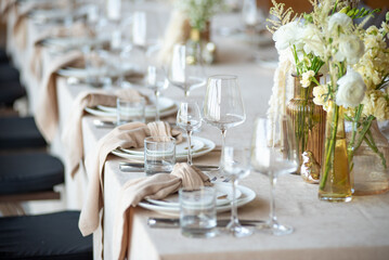 Beautiful wedding table decorations. Tablewear and bouquet of flowers.