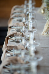 beautiful table setting with flowers and cutlery on wooden table at wedding or dinner. stylish tablewear decorations