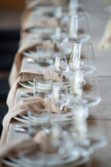 beautiful table setting with flowers and cutlery on wooden table at wedding or dinner. stylish tablewear decorations
