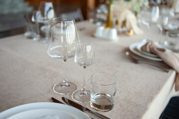 beautiful table setting with flowers and cutlery on wooden table at wedding or dinner. stylish tablewear decorations