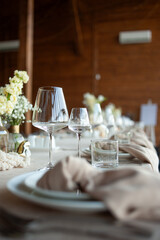 beautiful table setting with flowers and cutlery on wooden table at wedding or dinner. stylish tablewear decorations