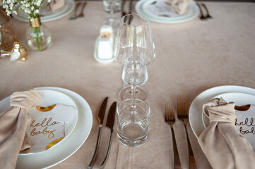 beautiful table setting with flowers and cutlery on wooden table at wedding or dinner. stylish tablewear decorations