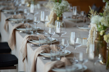 beautiful table setting with flowers and cutlery on wooden table at wedding or dinner. stylish...