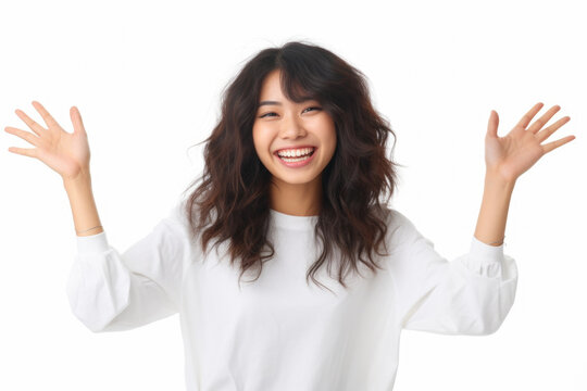 portrait of a young woman laughing and gesturing happily in studio setting against white background. She showcases positive emotion of enjoyment, reflecting her carefree and joyful life
