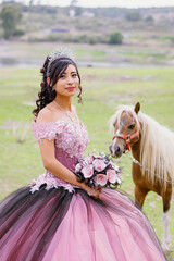 Portrait of a Mexican teen quinceanera, Hispanic teen girl wearing a dress