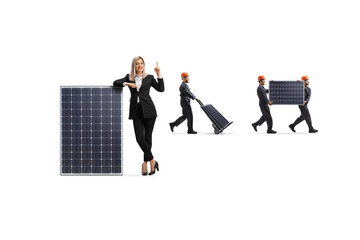 Fototapeta premium Businesswoman and factory workers with photovoltaic panels