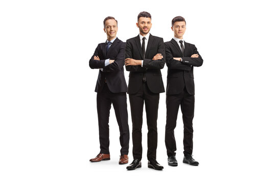 Three young businessmen in black suits posing