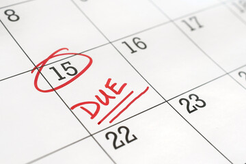 Calendar with the 15th of the month circled and word DUE written on it