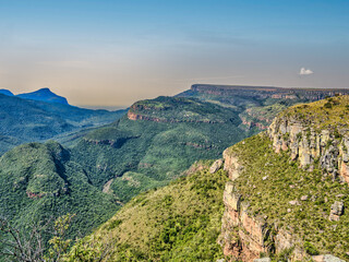 Fototapeta na wymiar Rocky mountain and lush foliage during a winter afternoon, Panorama Route, Graskop, Mpumalanga, South Africa