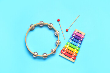 Different musical instruments on color background
