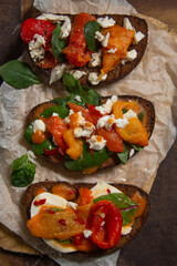 bruschetta set with herbs, cheese, and roasted peppers. 