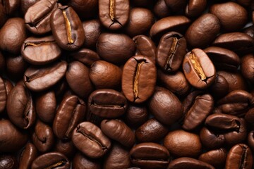 Fototapeta premium Fresh roasted coffee beans closeup pattern on dark background. Food pattern. Love coffee concept. Top view, flat lay with copy space