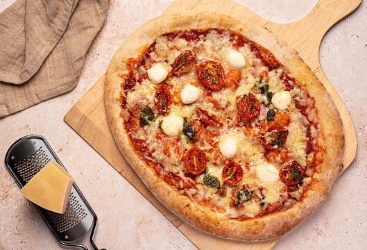 Food photography of pizza; mozzarella, dried, tomato, basil, pesto,; parmesan; cheese; tomato; sauce; oregano; spicy; background; meal; food