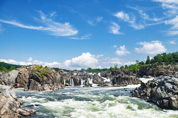 View of the Falls of the Potomac River in Virginia. A stormy stream of water among the rocks under...