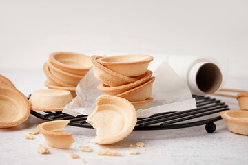 Grid with homemade tartlets on white background
