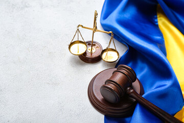 Judge's gavel, scales of justice and flag of Ukraine on white table
