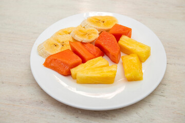 Chopped fruit for breakfast - Pineapple, banana and papaya.
