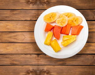 Chopped fruit for breakfast - Pineapple, banana and papaya.