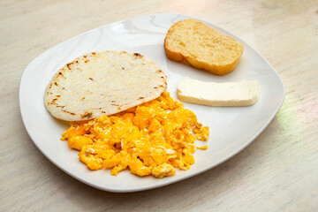 Traditional Colombian breakfast - Arepa with cheese, egg and bread