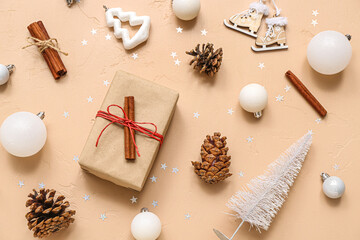 Fototapeta na wymiar Different Christmas decorations and gift box on beige background
