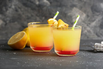 Glasses of tasty mai tai cocktail on black background