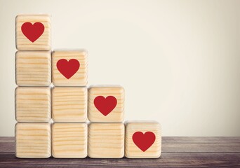 Increasing customer concept. Wooden cubes with red heart