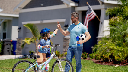 father and son kid navigate the path together. togetherness. Father and son enjoying a ride together. Supportive father guiding son first bike ride. Father and son sharing biking adventure