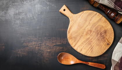 Abstract food background. Top view of dark rustic kitchen table with wooden cutting board and cooking spoon, frame. Banner or template with copy space for your design. Kitchen utensils objects