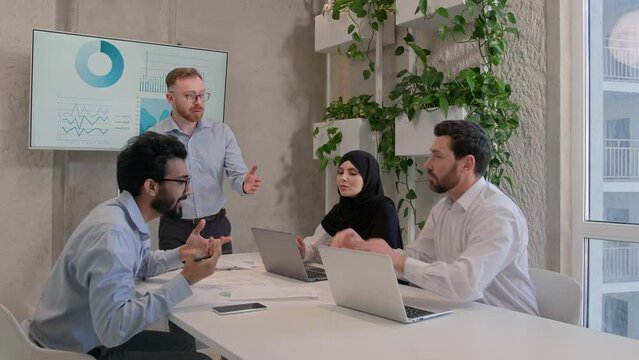 Emotional business team arguing at office discussing financial strategy graphics results diverse multiracial businessmen businesswoman dispute at corporate briefing solve issuess disagreement conflict