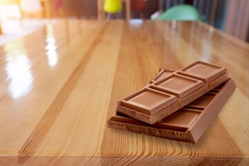 Tasty sweet chocolate bar on wooden desk