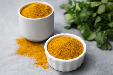 Aromatic curry powder on light grey table, closeup