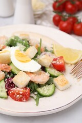 Delicious Caesar salad with shrimps on white table, closeup