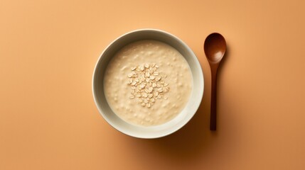Top view of bowl of oatmeal on yellow background, minimal design. - obrazy, fototapety, plakaty