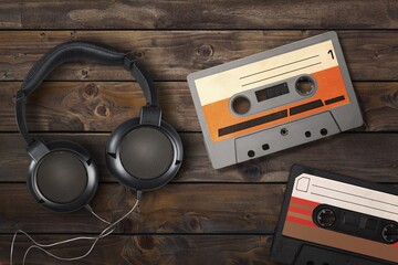 Vintage retro audio cassette and headphones on desk